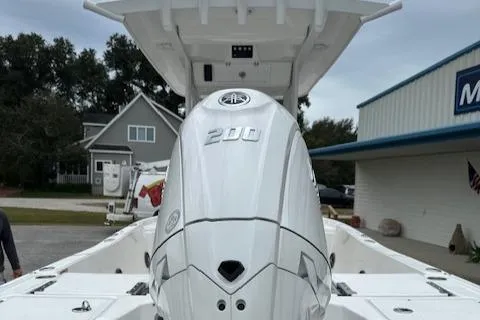 Slide: The Image of 2024 Sea Fox 231 Bay Fox boat with a 200 HP engine at a marina. - 6