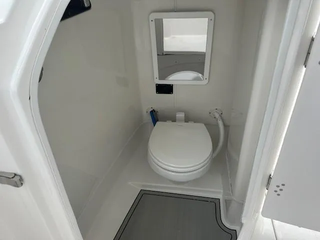 Slide: The Image of 2024 Sea Fox 268 Traveler boat interior bathroom with toilet and mirror. - 10