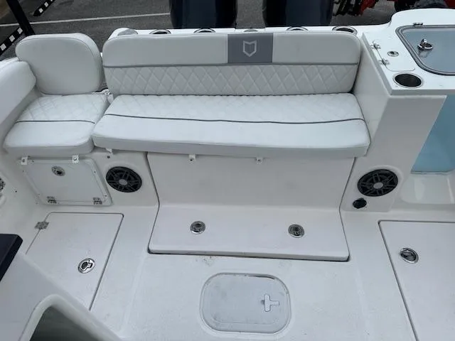 Slide: The Image of 2024 Sea Fox 268 Traveler boat interior with white cushioned seating and storage compartments. - 12