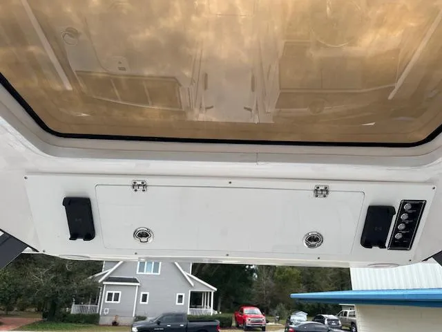 Slide: The Image of 2024 Sea Fox 268 Traveler boat console with overhead storage and controls. - 7