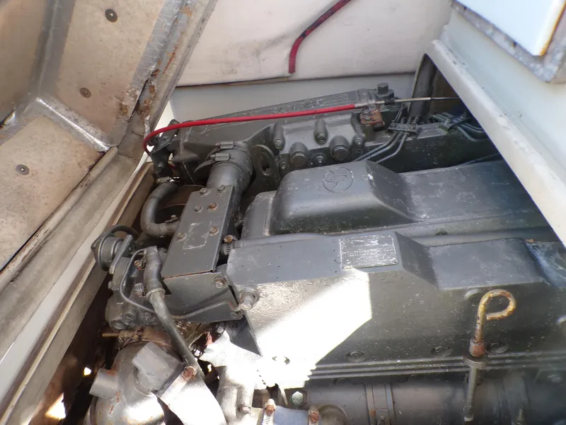 Slide: The Image of 1985 Boston Whaler Dual Console engine compartment, showcasing mechanical components and wiring. - 10