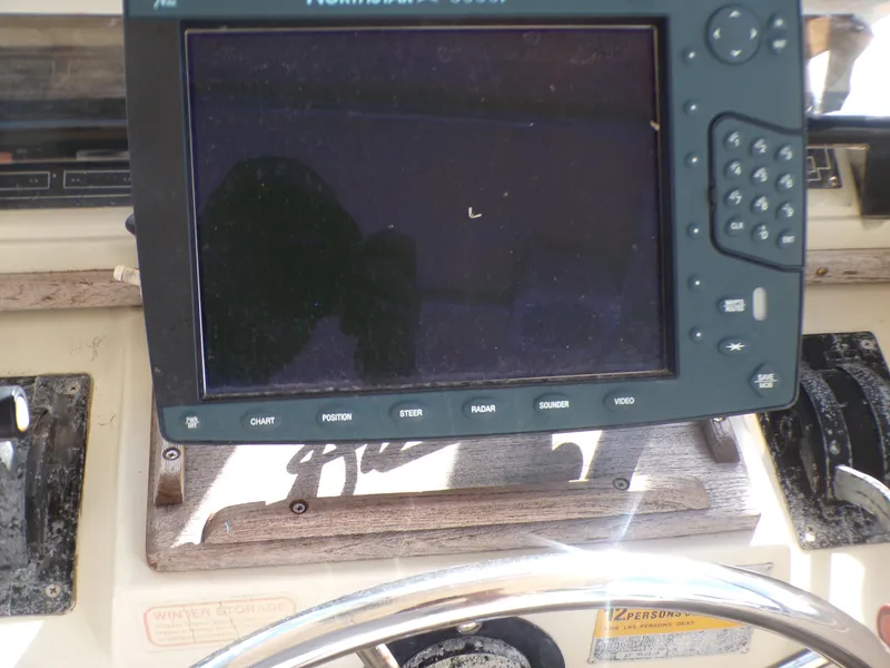 Slide: The Image of 1985 Boston Whaler Dual Console dashboard with navigation equipment. - 11