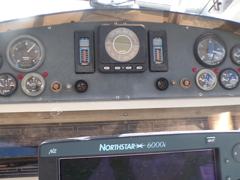 Slide: The Image of 1985 Boston Whaler Dual Console dashboard with gauges and Northstar 6000i navigation system. - 12