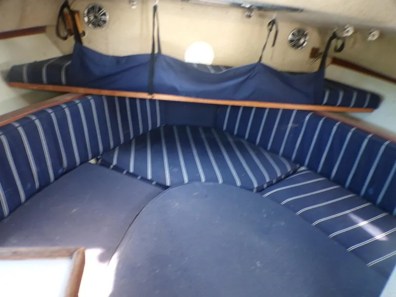 Slide: The Image of Interior of 1985 Boston Whaler Dual Console with blue striped seating. - 14