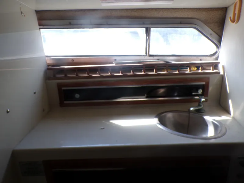 Slide: The Image of Interior of a 1985 Boston Whaler Dual Console boat with sink and window. - 17