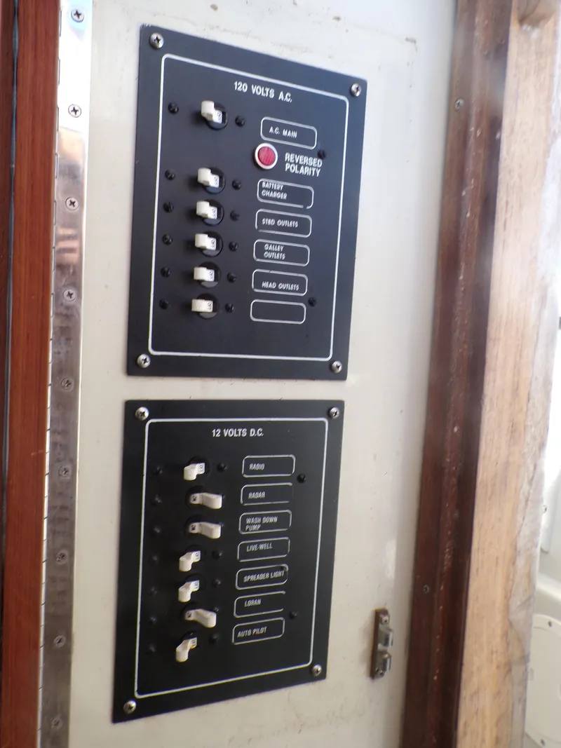 Slide: The Image of 1985 Boston Whaler Dual Console electrical panel with switches and labels. - 19