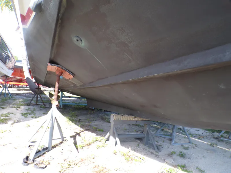 Slide: The Image of 1985 Boston Whaler Dual Console boat hull on stands, outdoor storage. - 2