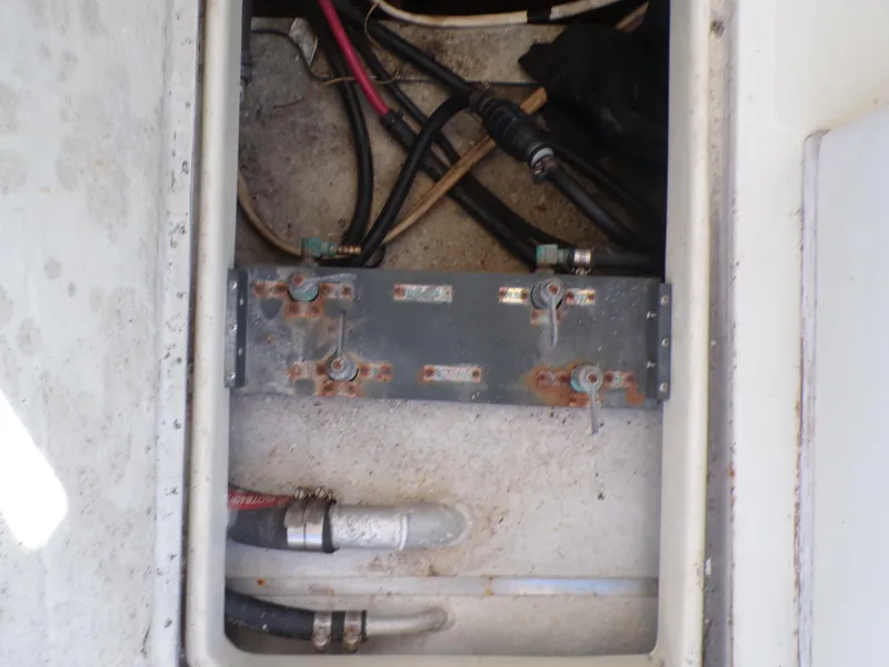 Slide: The Image of 1985 Boston Whaler Dual Console wiring compartment with visible cables and connectors. - 20