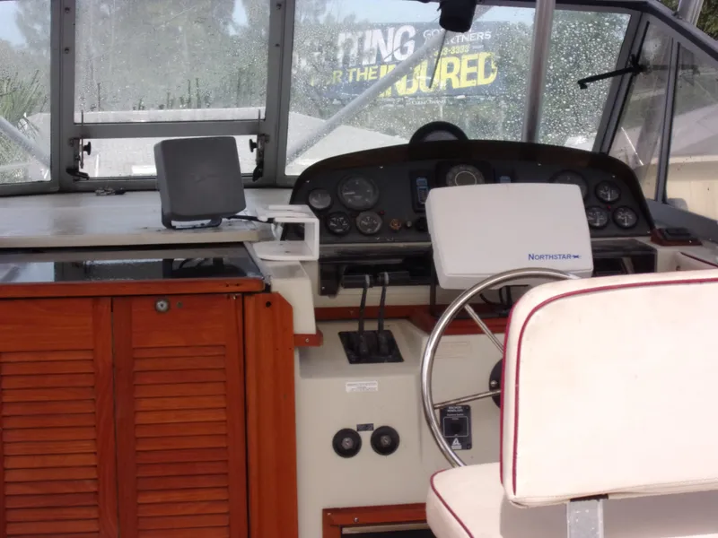 Slide: The Image of 1985 Boston Whaler Dual Console boat interior with steering wheel and control panel. - 3