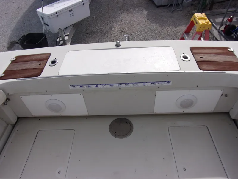 Slide: The Image of 1985 Boston Whaler Dual Console boat interior with storage compartments and speakers. - 4