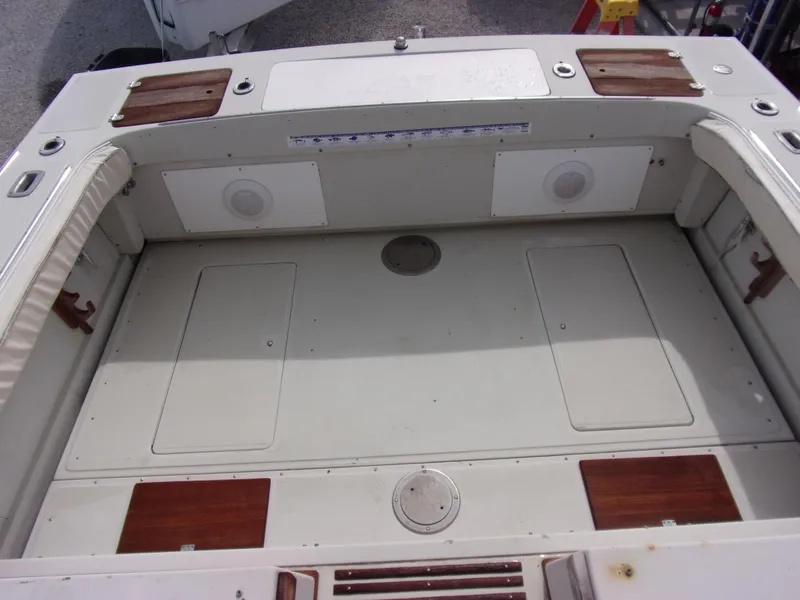 Slide: The Image of 1985 Boston Whaler Dual Console boat deck with storage compartments and speakers. - 5