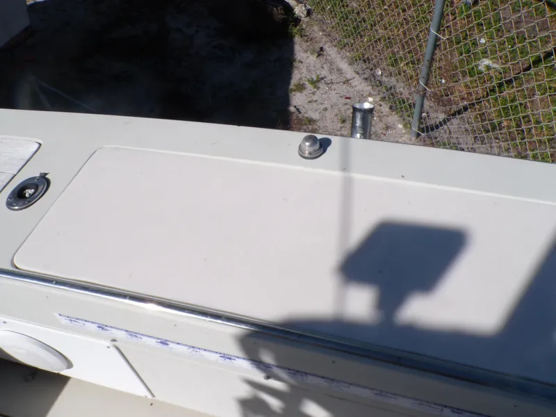 Slide: The Image of 1985 Boston Whaler Dual Console boat deck with metal fixtures and shadow. - 9