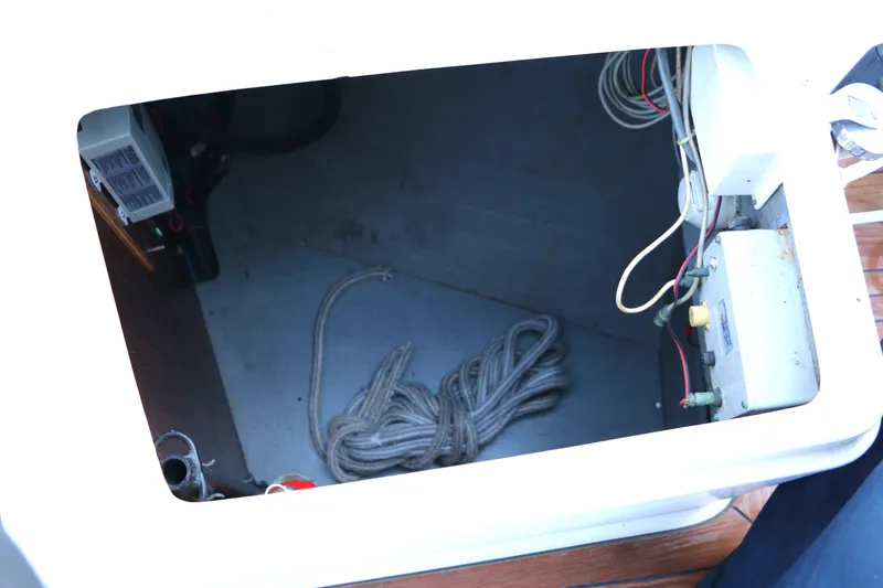 Slide: The Image of Storage compartment of a 1985 Baltic 35 sailboat with coiled rope and wiring. - 11