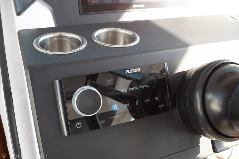 Slide: The Image of Control panel of 2018 Axopar 37 Sun-Top with Fusion audio system and cup holders. - 12
