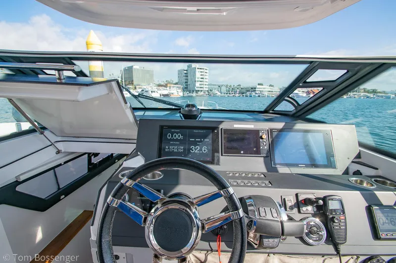 Slide: The Image of Cockpit view of 2018 Axopar 37 Sun-Top boat with modern navigation equipment. - 17