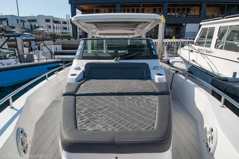 Slide: The Image of 2018 Axopar 37 Sun-Top boat with cushioned deck, docked at marina. - 20