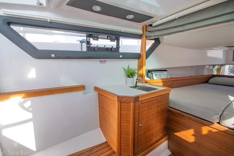 Slide: The Image of 2018 Axopar 37 Sun-Top interior with wooden cabinetry and modern design. - 23