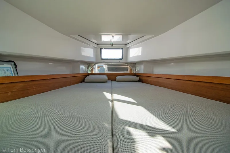 Slide: The Image of Interior cabin of 2018 Axopar 37 Sun-Top with cozy bedding and natural light. - 26