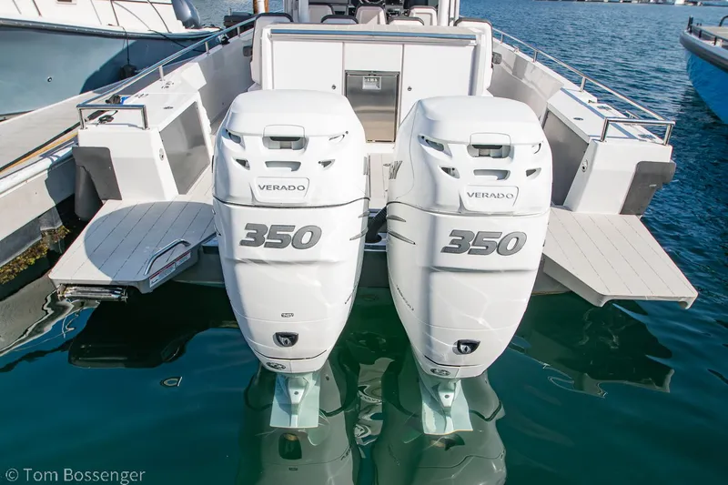 Slide: The Image of 2018 Axopar 37 Sun-Top with twin 350 Verado engines docked in water. - 29