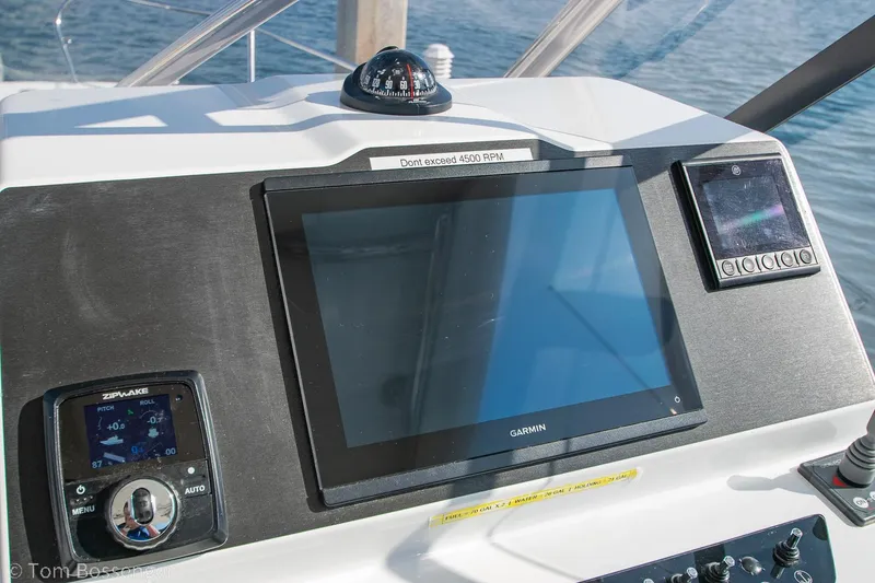 Slide: The Image of Control panel of 2022 Beneteau Flyer 9 boat with navigation screens and compass. - 11