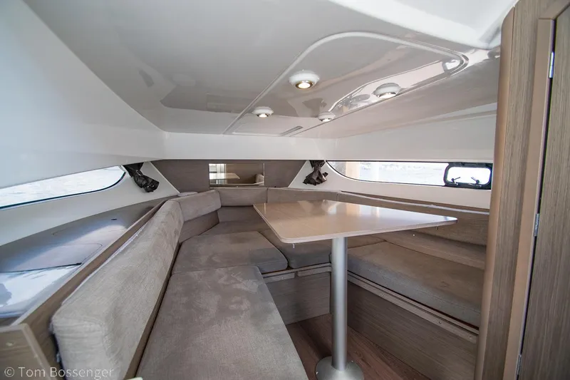Slide: The Image of Interior of 2022 Beneteau Flyer 9, featuring a cozy seating area with a wooden table. - 16