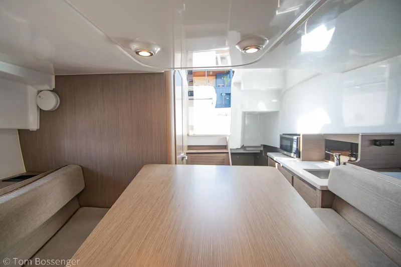 Slide: The Image of Interior of 2022 Beneteau Flyer 9, featuring modern dining area and kitchenette. - 17