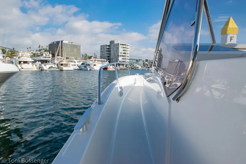 Slide: The Image of 2022 Beneteau Flyer 9 boat docked in a marina with cityscape background. - 22