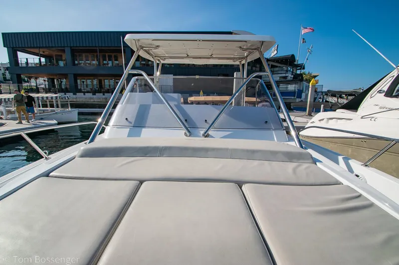 Slide: The Image of 2022 Beneteau Flyer 9 boat with sunbed, docked at marina under clear blue sky. - 24