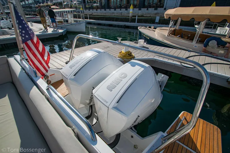 Slide: The Image of 2022 Beneteau Flyer 9 with dual outboard engines docked at a marina. - 26