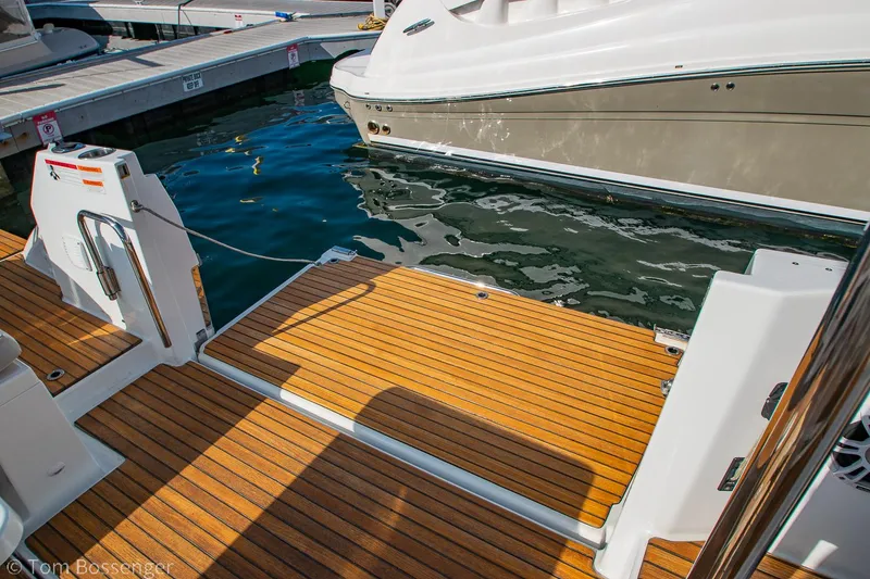 Slide: The Image of 2022 Beneteau Flyer 9 boat deck with wooden finish at marina. - 27