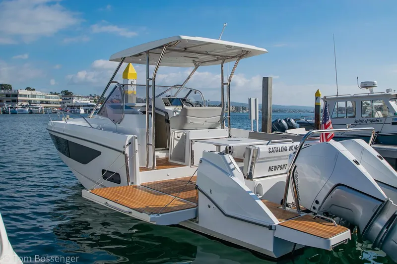 Slide: The Image of 2022 Beneteau Flyer 9 boat docked in a marina, featuring a sleek design and spacious deck. - 28