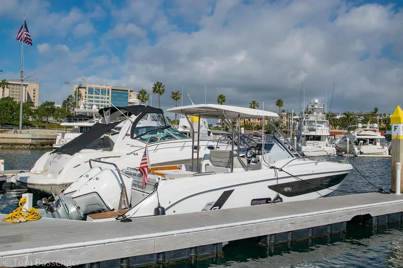 Slide: The Image of Beneteau Flyer 9 boat docked at marina, 2022 model, with American flag and clear skies. - 3