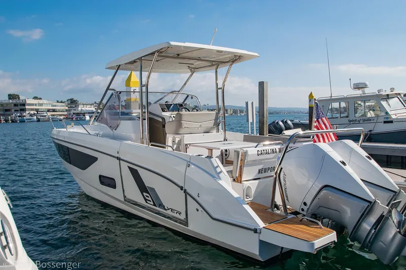 Slide: The Image of 2022 Beneteau Flyer 9 boat docked in a marina, featuring twin outboard engines. - 4