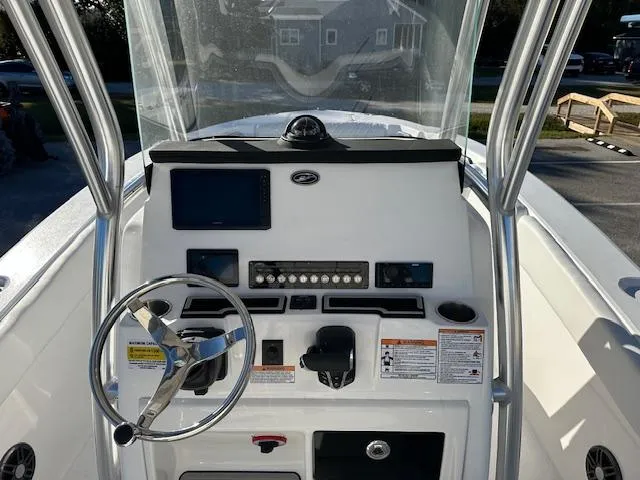 Slide: The Image of 2024 Sea Fox 228 Commander boat console with steering wheel and navigation controls. - 4