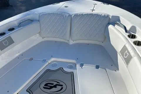 Slide: The Image of 2024 Sea Fox 228 Commander boat interior with cushioned seating and cup holders. - 8