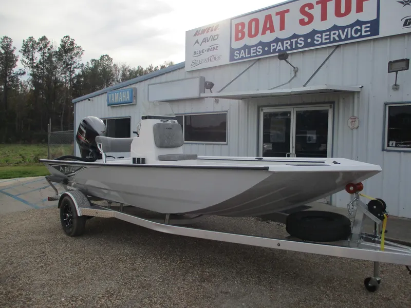 Slide: The Image of 2024 Avid 18 Rogue CC boat on trailer outside dealership. - 1