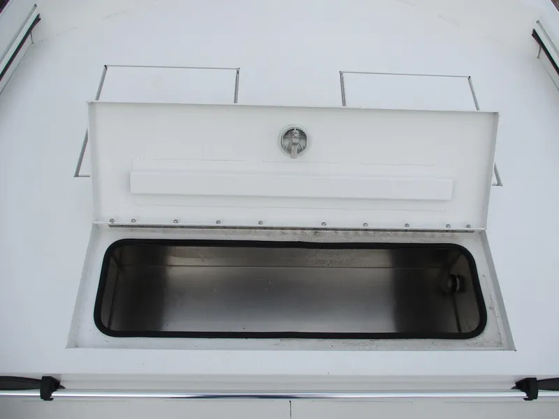 Slide: The Image of Open storage compartment on the 2024 Avid 18 Rogue CC boat. - 11