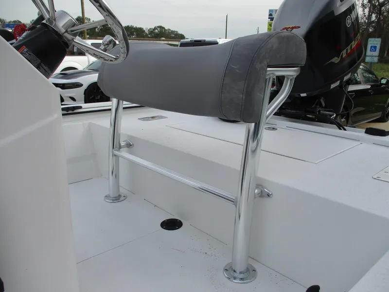 Slide: The Image of 2024 Avid 18 Rogue CC boat console with cushioned seat and steering wheel. - 13