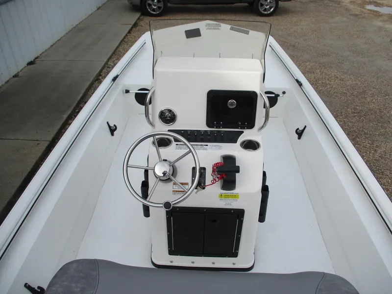 Slide: The Image of 2024 Avid 18 Rogue CC boat console with steering wheel and controls. - 14