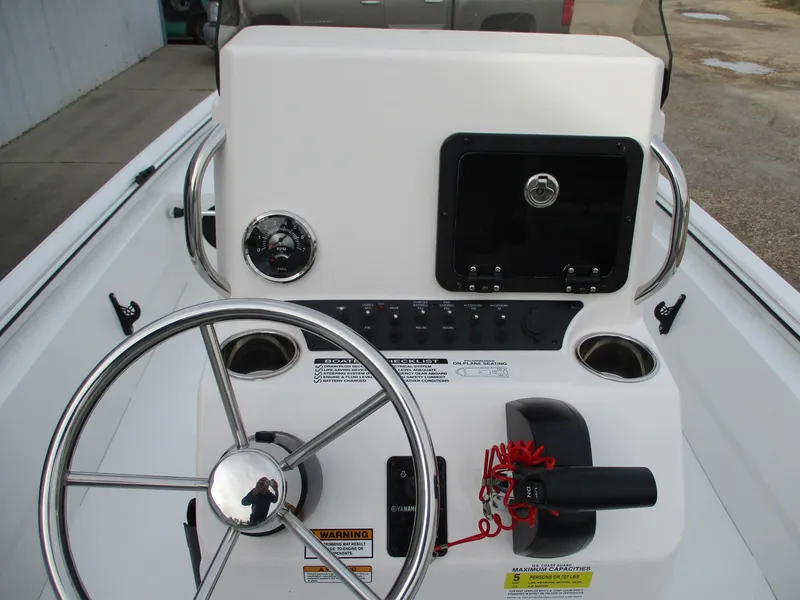 Slide: The Image of 2024 Avid 18 Rogue CC boat console with steering wheel and control panel. - 15