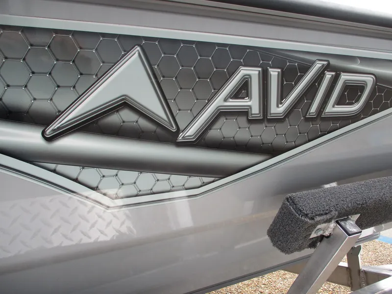 Slide: The Image of 2024 Avid 18 Rogue CC boat with hexagonal pattern and logo. - 17