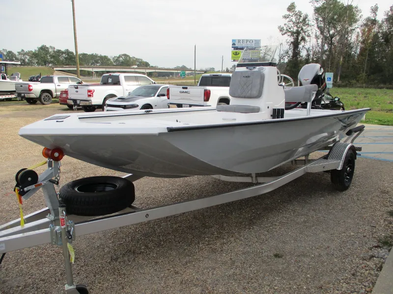 Slide: The Image of 2024 Avid 18 Rogue CC boat on a trailer in a parking lot. - 2