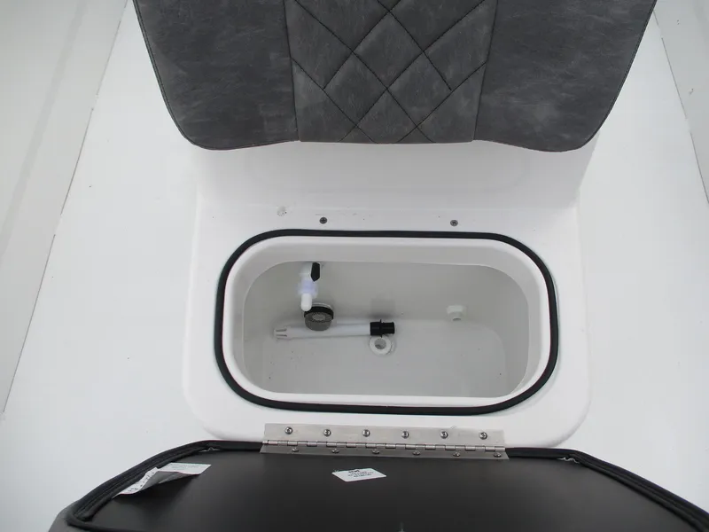 Slide: The Image of 2024 Avid 18 Rogue CC boat storage compartment with cushioned seat. - 8