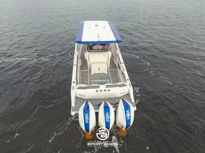 Slide: The Image of 2021 Nor-Tech 390 Sport boat with triple outboard engines on the water. - 16