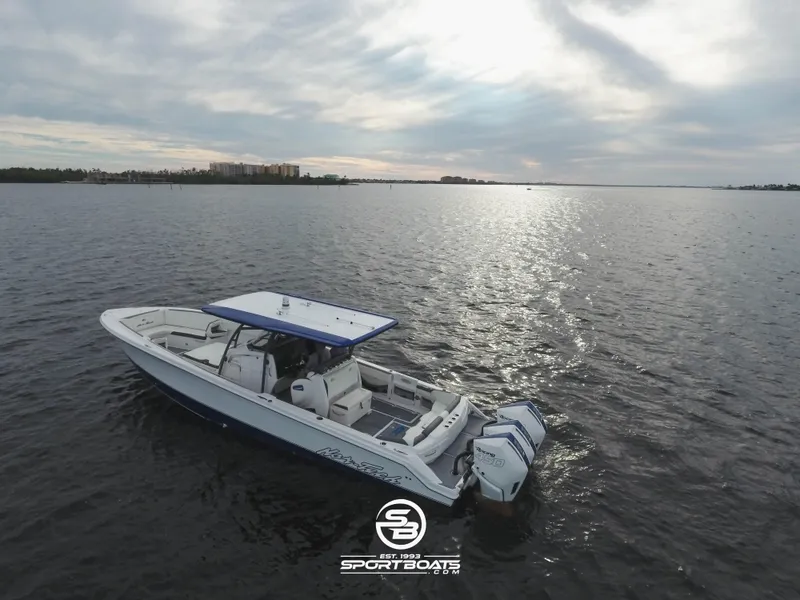 Slide: The Image of 2021 Nor-Tech 390 Sport boat on calm waters at sunset. - 18
