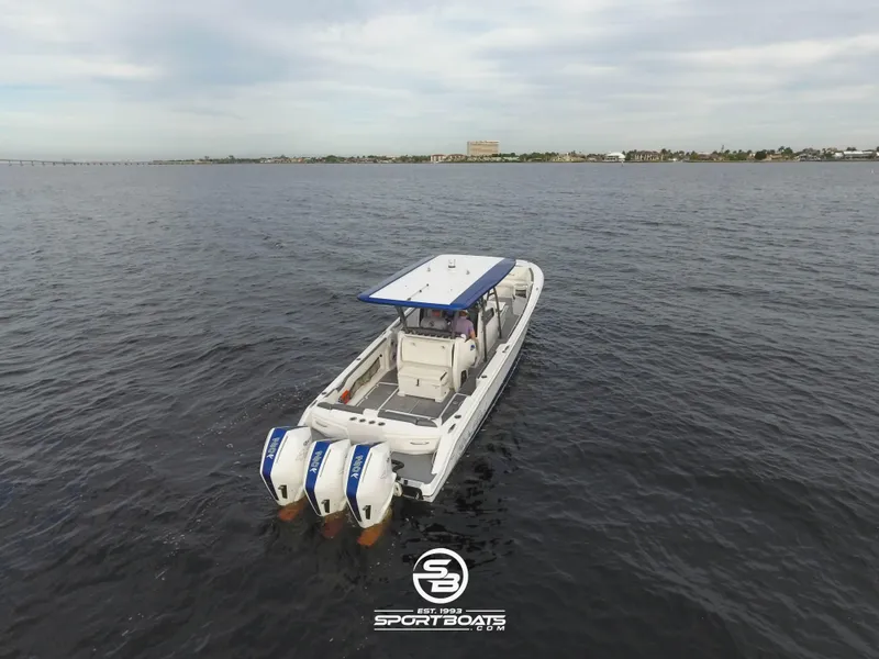 Slide: The Image of 2021 Nor-Tech 390 Sport boat with triple outboard engines on open water. - 9