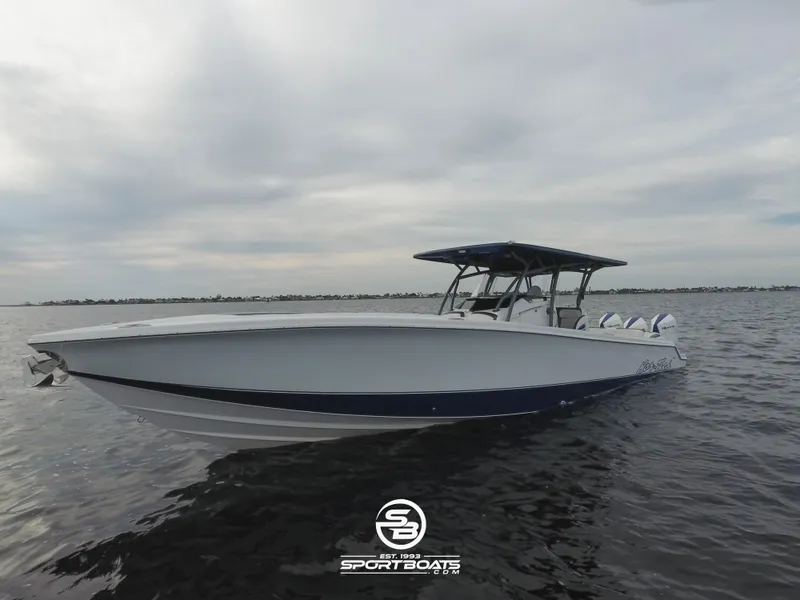 The Image of 2021 Nor-Tech 390 Sport boat on calm waters under a cloudy sky. - 0