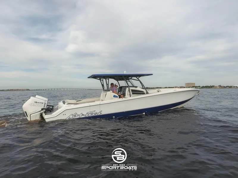 Slide: The Image of 2021 Nor-Tech 390 Sport boat cruising on open water. - 12