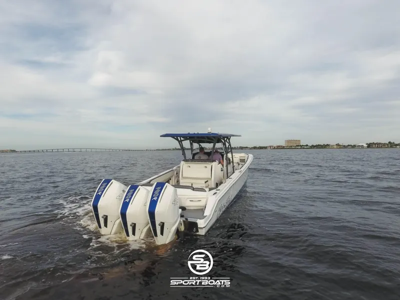 Slide: The Image of 2021 Nor-Tech 390 Sport boat with triple outboard engines on open water. - 13