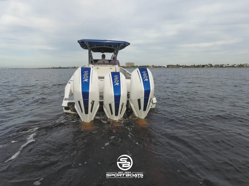 Slide: The Image of 2021 Nor-Tech 390 Sport boat with triple outboard engines on the water. - 17